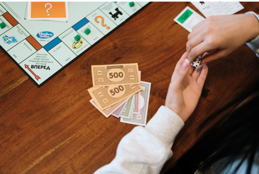 Illustration of a Monopoly-style game board highlighting productive real estate as a long-term wealth building asset.